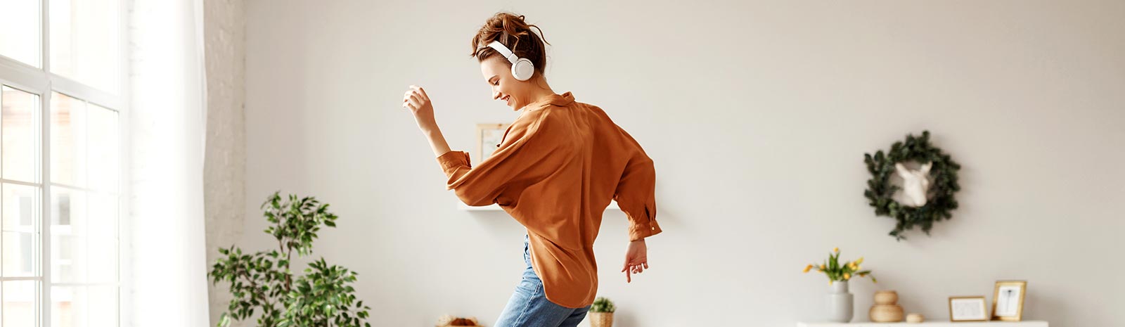 Woman dancing with headset on.